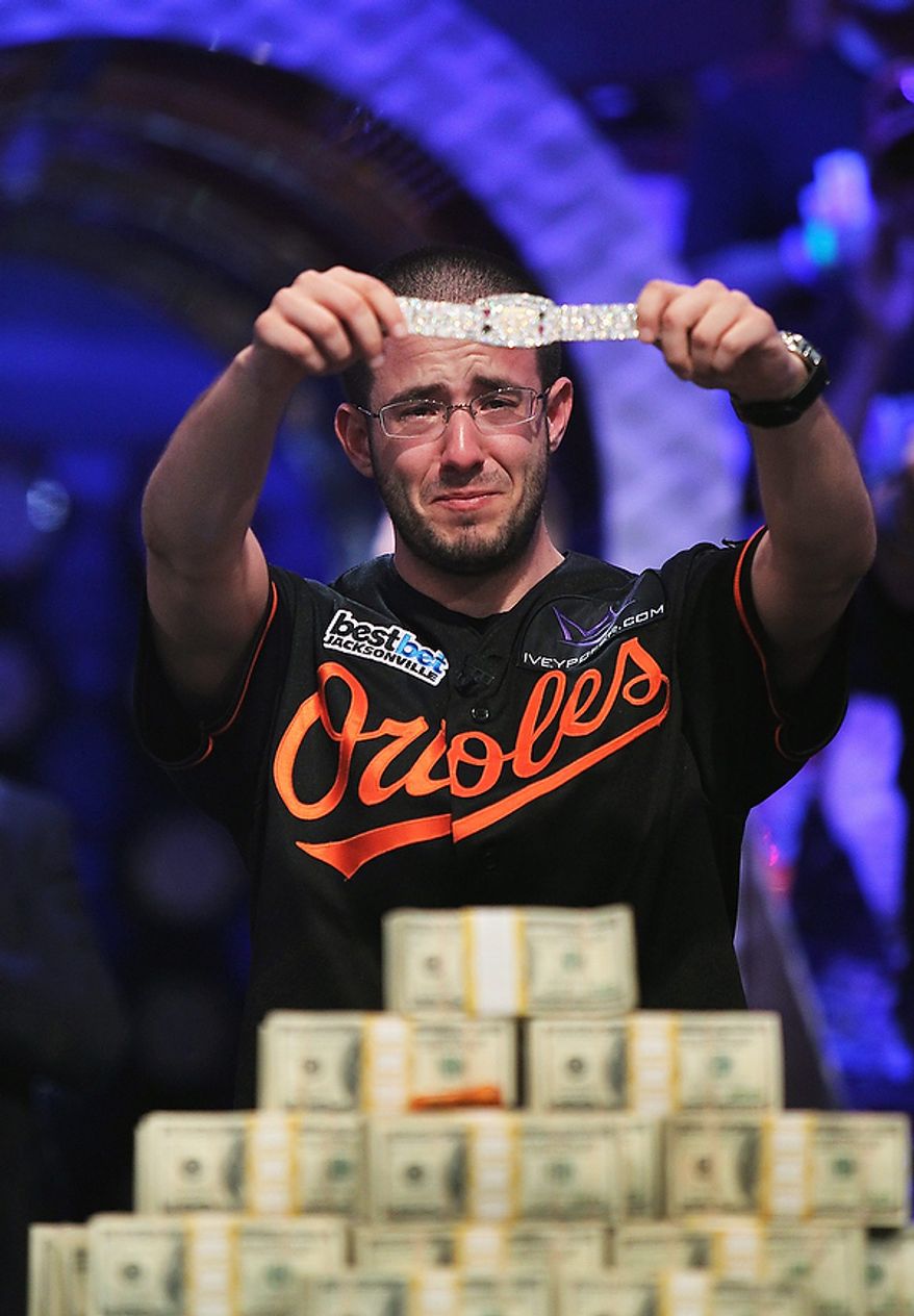 Greg Merson holds up his new bracelet after winning the World Series of Poker No-Limit Hold'em Main Event, Wednesday, Oct. 31, 2012, in Las Vegas. (AP Photo/Las Vegas Review-Journal, Jason Bean)