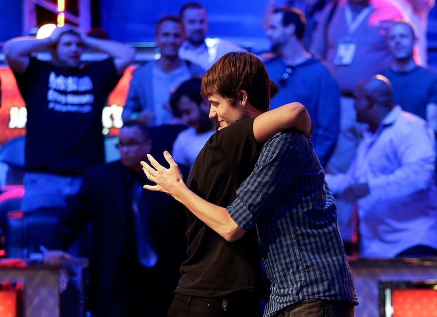 Jake Balsiger hugs Jesse Sylvia after being eliminated from play to finish third during the World Series of Poker Final Table event, Wednesday, Oct. 31, 2012, in Las Vegas. (AP Photo/Julie Jacobson)