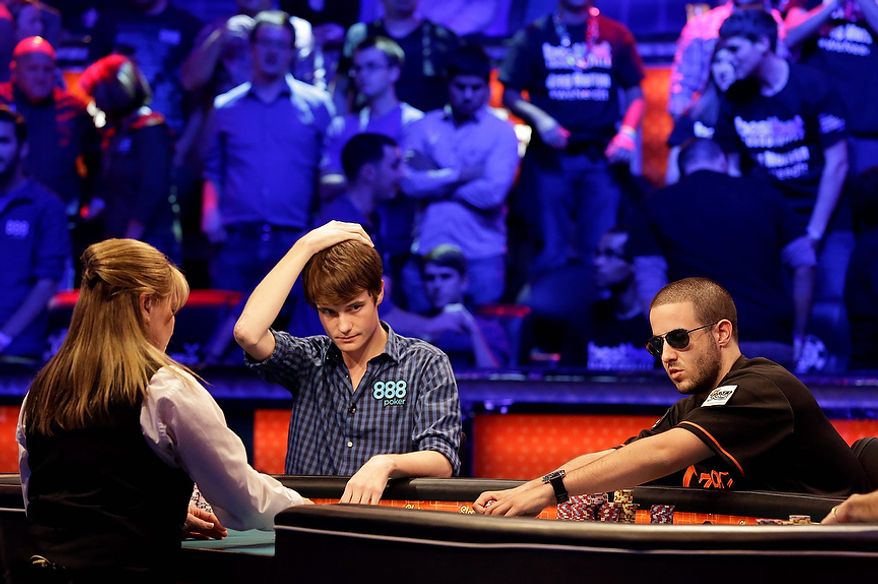 Jake Balsiger, left, reacts as Greg Merson pulls in the pot after snap folding on an all in bet by Merson during the World Series of Poker Final Table event, Tuesday, Oct. 30, 2012, in Las Vegas. (AP Photo/Julie Jacobson)