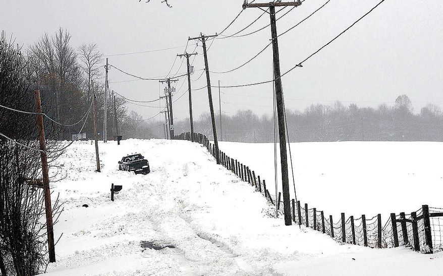 A truck makes it way through a snow-covered road in Beaver, W.Va., Wednesday, Oct. 31, 2012. Superstorm Sandy has already dumped up to 2 feet of snow in West Virginia, cutting electricity to about 271,00 customers and closing dozens of roads. (AP Photo/The Register-Herald, Rick Barbero)