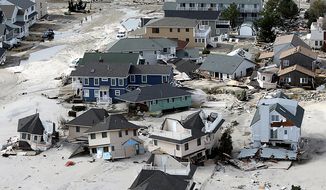 This aerial photo shows destroyed houses left in the wake of superstorm Sandy on Wednesday, Oct. 31, 2012, in Seaside Heights, N.J. (AP Photo/Mike Groll)