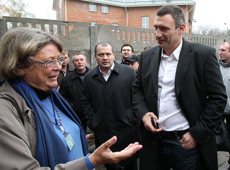 Vitali Klitschko (right), chairman of the Ukrainian opposition party Udar (Punch) and WBC heavyweight champion boxer, speaks with international election observer Hanne Severinsen in Brovary, Ukraine, on Tuesday, Oct. 30, 2012. Ukrainian opposition parties are scrambling for position after the ruling party scored a confident victory in parliamentary elections denounced as unfair by international observers. (AP Photo/Olexander Kosarev)