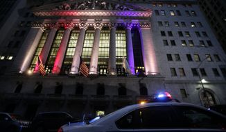 A police car patrols in front of the New York Stock Exchange, Wednesday, Oct. 31, 2012, before it reopens for trading for the first time this week following a two-day shutdown due to superstorm Sandy. Stock futures are rising ahead of the opening bell. (AP Photo/Mark Lennihan)

