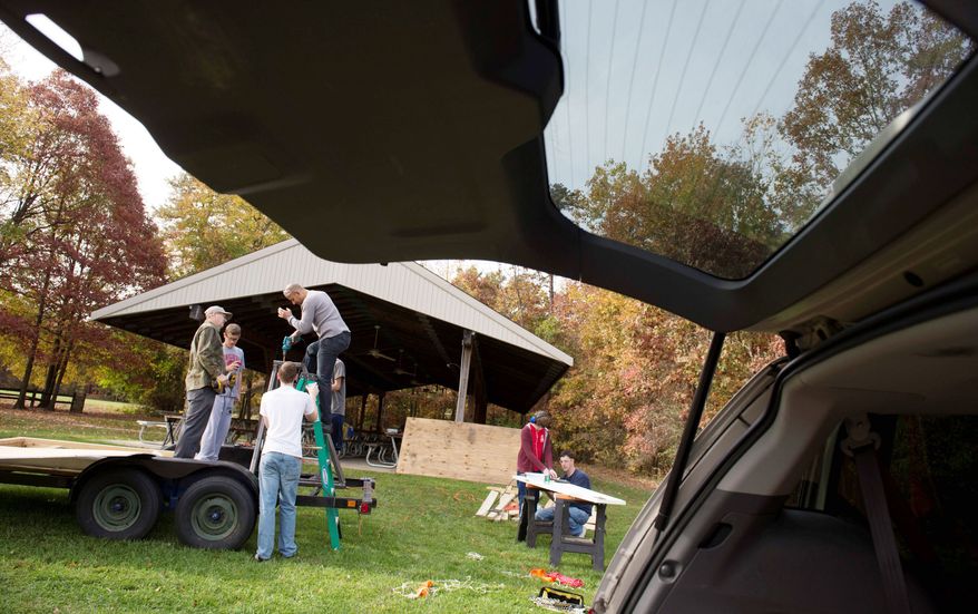 Members of Scout Troop 672 in Severn, Md., have created a catapult they hope will throw a pumpkin farther than last year’s contraption at the Punkin Chunkin competition. Helping are is RJ Joyce, 16, of Odenton, Md., under the supervision of his father, Assistant Scoutmaster Rob Joyce. (Rod Lamkey Jr./The Washington Times)