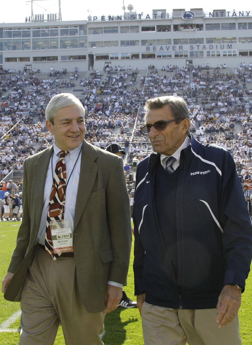 FILE - In this Oct. 8, 2011, file photo Penn State president Graham Spanier, left, and head football coach Joe Paterno talk before an NCAA college football game against Iowa in State College, Pa. Spanier is accused of perjury, endangering children and other charges in the Jerry Sandusky molestation scandal. According to online court records charges were filed, Thursday, Nov. 1, 2012, against Penn State's ex-president and two other administrators in what prosecutors called “a conspiracy of silence." (AP Photo/Gene Puskar, File)