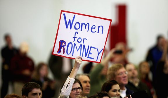 A supporter holds up a sign as Republican presidential candidate, former Massachusetts Gov. Mitt Romney makes a speech at a campaign event at a window and door factory, Thursday, Nov. 1, 2012, in Roanoke, Va. (AP Photo/The Roanoke Times, Jeanna Duerscherl)  