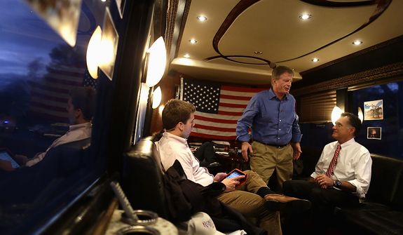 Republican presidential candidate and former Massachusetts Gov. Mitt Romney, chief strategist Stuart Stevens, center, and and aide Garrett Jackson are pictured on the campaign bus as they leave a campaign event at Meadow Event Park, in Dowell, Va., for another rally in Virginia Beach, Va., Thursday, Nov. 1, 2012. (AP Photo/Charles Dharapak)