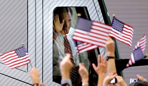 Supporters wave American flags and Republican presidential candidate, former Massachusetts Gov. Mitt Romney waves as he arrives in his campaign bus for a campaign event at Meadow Event Park Thursday, Nov. 1, 2012, in Doswell, Va. (AP Photo/David Goldman)