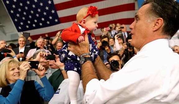 Republican presidential candidate, former Massachusetts Gov. Mitt Romney picks up a baby as he campaigns at Meadow Event Park, in Richmond, Va., Thursday, Nov. 1, 2012. (AP Photo/Charles Dharapak)