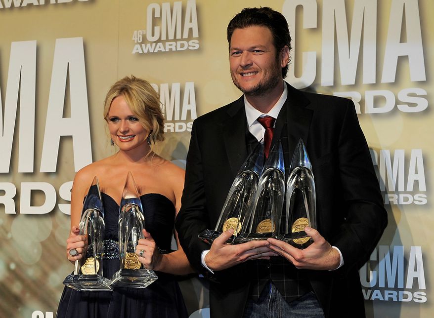 Miranda Lambert, winner of the awards for song of the year for "Over You" and female vocalist of the year, left, and Blake Shelton, winner of the awards for male vocalist of the year, song of the year for "Over You" and entertainer of the year, pose backstage at the 46th Annual Country Music Awards at the Bridgestone Arena on Thursday, Nov. 1, 2012, in Nashville, Tenn. (Photo by Chris Pizzello/Invision/AP)