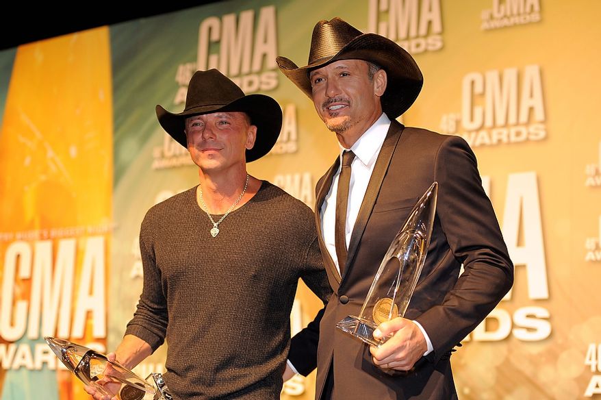 Kenny Chesney, left, and Tim McGraw pose backstage with their awards for musical event of the year at the 46th Annual Country Music Awards at the Bridgestone Arena on Thursday, Nov. 1, 2012, in Nashville, Tenn. (Photo by Chris Pizzello/Invision/AP)