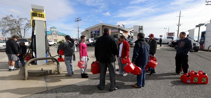 A line forms at a gas pump as people wait to fill up cans on Thursday, Nov. 1, 2012, as many are left without power following Superstorm Sandy, in Toms River, N.J. Sandy, the storm that made landfall Monday, caused multiple fatalities. (AP Photo/Julio Cortez)