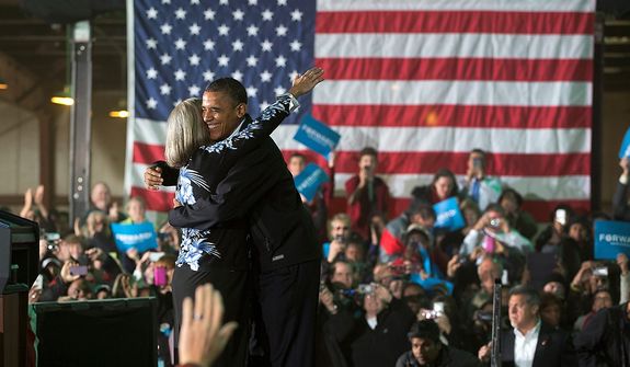 President Barack Obama is hugged by Judith Kamalay as he arrives to speak at a campaign event at the Franklin County Fairgrounds, Friday, Nov. 2, 2012, in Hilliard, Ohio, before heading to another campaign stop in in Springfield, Ohio. (AP Photo/Carolyn Kaster)