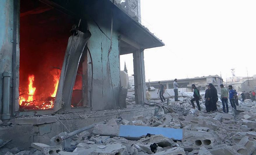 In this Thursday November 1, 2012, citizen journalism image provided by Edlib News Network, ENN, which has been authenticated based on its contents and other AP reporting, Syrians inspect shops and a mosque which were damaged in shelling by Syrian forces loyal to Syrian President Bashar Assad, in the village of Taftanaz, Idlib province, northern Syria. Syrian rebels killed more than 75 soldiers on Thursday, about half of them in attacks on military checkpoints in the north just hours after a wave of bombings hit the Damascus area, activists said. The unusually high toll for regime forces came after days of intense air bombardment of rebel positions around the country that killed hundreds. (AP Photo/Idlib News Network ENN)