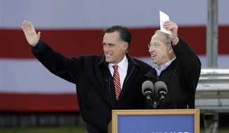 Republican presidential candidate, former Massachusetts Gov. Mitt Romney and Sen. Charles Grassley, R-Iowa, wave before Romney spoke about the economy during a campaign stop at Kinzler Construction Services, Friday, Oct. 26, 2012, in Ames, Iowa. (AP Photo/Charlie Neibergall)