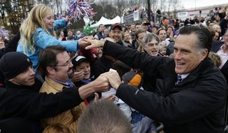 Republican presidential candidate and former Massachusetts Gov. Mitt Romney greets supporters as he campaigns at Portsmouth International Airport, in Newington, N.H., Saturday, Nov. 3, 2012. (AP Photo/Charles Dharapak)