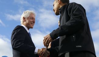 President Obama (right) and former President Bill Clinton shake hands onstage during a campaign event at Capitol Square in Concord, N.H., on Sunday, Nov. 4, 2012. (AP Photo/Pablo Martinez Monsivais)