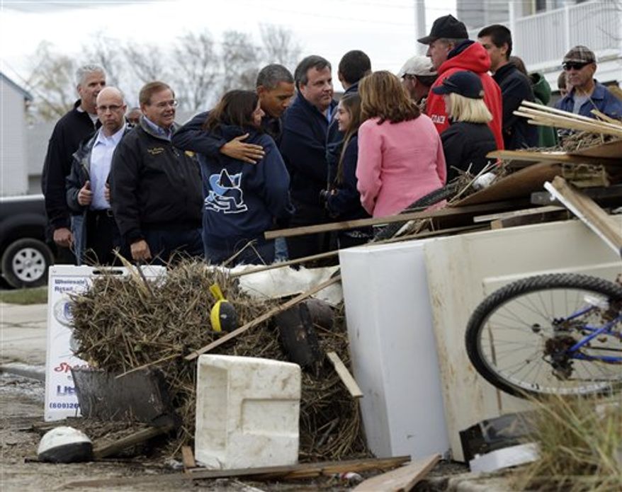 President Obama, center, and and Gov. Chris Christie meet with local residents as they tour neighborhood effected by superstorm Sandy, Wednesday, Oct. 31, 2012 in Brigantine, N.J. (AP Photo/Pablo Martinez Monsivais)