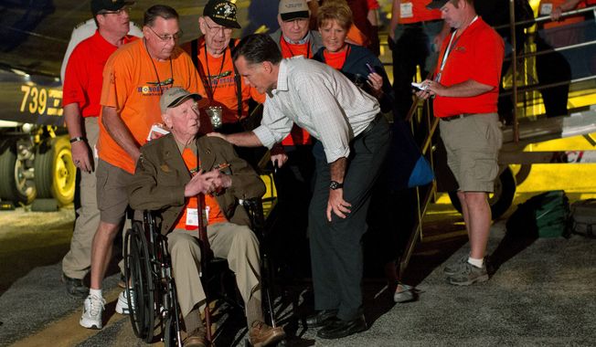 **FILE** Republican presidential candidate Mitt Romney shakes hands in Swanton, Ohio, with World War II and Korean War veterans returning on an Honor Flight from Washington on Sept. 26, 2012. (Associated Press)