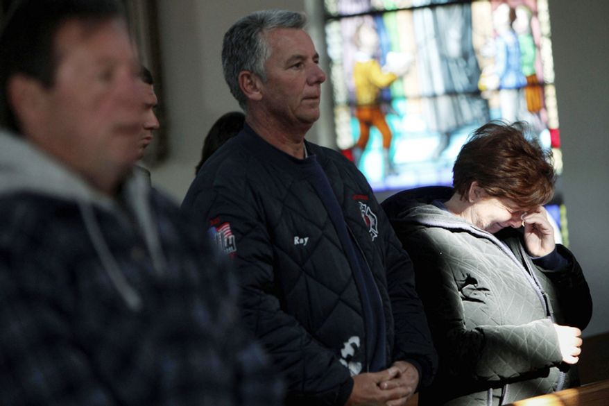 Maryann Eger cries during Mass in the New Dorp neighborhood of Staten Island, N.Y., Sunday, Nov. 4, 2012, as the region copes in the aftermath of Superstorm Sandy. (AP Photo/Seth Wenig)