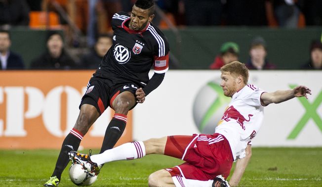 D.C. United forward Lionard Pajoy (26) dodges New York Red Bulls defender Markus Holgersson (5) during the first half of the Eastern Conference semifinals playoff match at RFK Stadium, Washington, D.C., Saturday, Nov. 3, 2012. (Craig Bisacre/The Washington Times) 