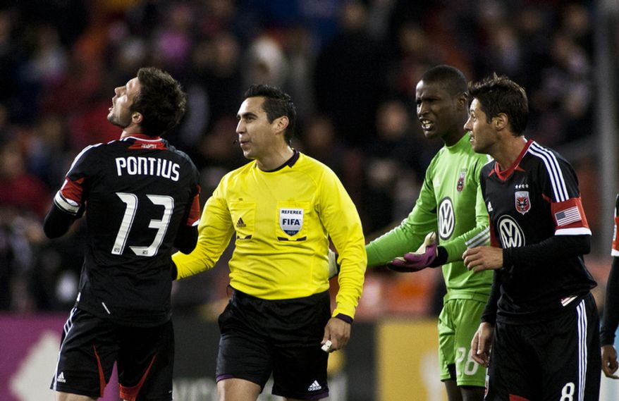 D.C. United midfielder Chris Pontius (13) and goalkeeper Bill Hamid (28) argue the ruling of an own goal by goalkeeper Bill Hamid during the second half against the New York Red Bulls in the Eastern Conference semifinals playoff match at RFK Stadium, Washington, D.C., Saturday, Nov. 3, 2012. (Craig Bisacre/The Washington Times)
