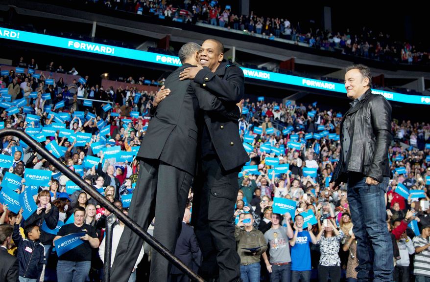 President Obama hugs Jay-Z as Bruce Springsteen looks on at a campaign event at Nationwide Arena in Columbus, Ohio, on Monday. Mr. Obama and Mitt Romney are wooing voters in Ohio, which has chosen the winner in the last 12 presidential elections and is pivotal to the strategies of both hopefuls. The state’s geography is often divided regionally as the “Five Ohios.” (Associated Press)
