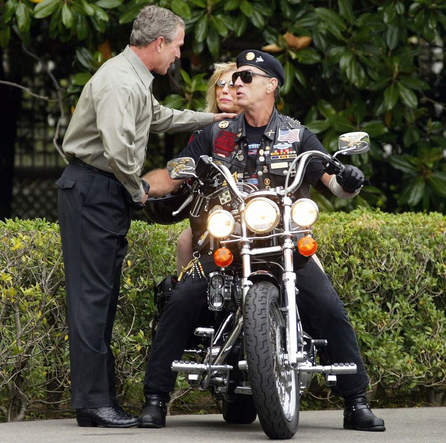 President Bush greets Artie Muller, executive director of Rolling Thunder, and singer Nancy Sinatra at the White House in 2004. The motorcycle group is strongly supporting Mitt Romney for president. (Associated Press)