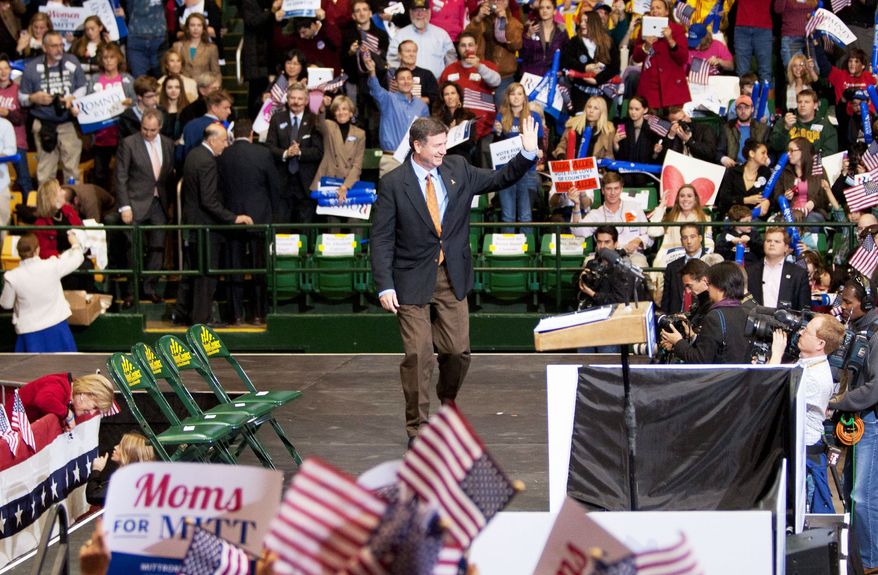 George Allen, campaigning to return to the Senate, acknowledges supporters at a joint rally Monday with the Republican presidential nominee Mitt Romney. An overflow crowd estimated at 11,500 attended the Monday event at George Mason University. (Craig Bisacre/The Washington Times)