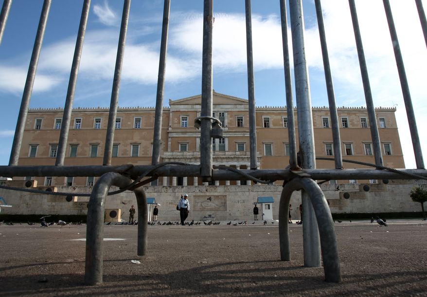 Police fences protect the Greek parliament in central Athens on Nov. 5, 2012, ahead of a 48-hour nationwide general strike. Greece is facing three days of escalating anti-austerity strikes, with state hospital doctors, taxi drivers, transport workers and journalists walking off the job. (Associated Press)