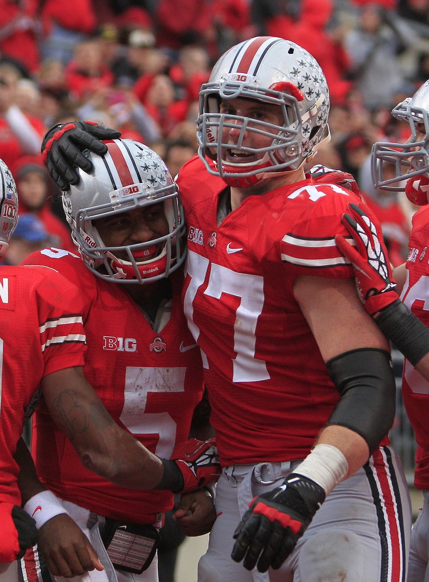 Ohio State quarterback Braxton Miller (left) celebrates his touchdown against Illinois with teammate Reid Fragel during the third quarter of Ohio State's 52-22 win over Illinois on Nov. 3, 2012, in Columbus, Ohio. (Associated Press)