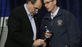 David Axelrod (left), senior adviser for the Obama campaign, and David Plouffe, White House senior adviser, talk during a campaign event for President Obama on Nov. 2, 2012, at Springfield High School in Springfield, Ohio. (Associated Press)