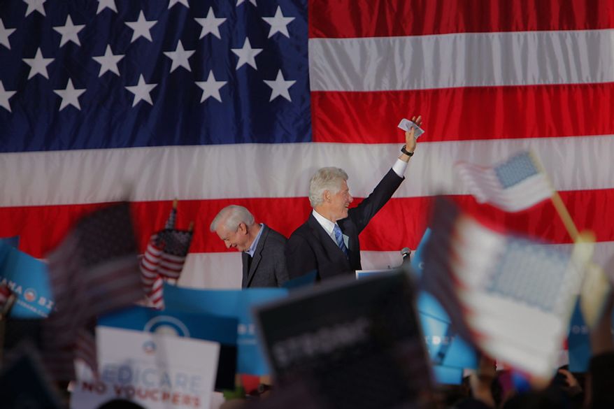 Former President Bill Clinton (right) arrives Nov. 4, 2012, at a rally for President Obama at Pullen Park in Raleigh, N.C., after being introduced by former North Carolina Gov. Jim Hunt (left). The former president has been traveling to several battleground states over the past week to try to stem any Republican tide for Mitt Romney and preserve Obama leads. (Associated Press)