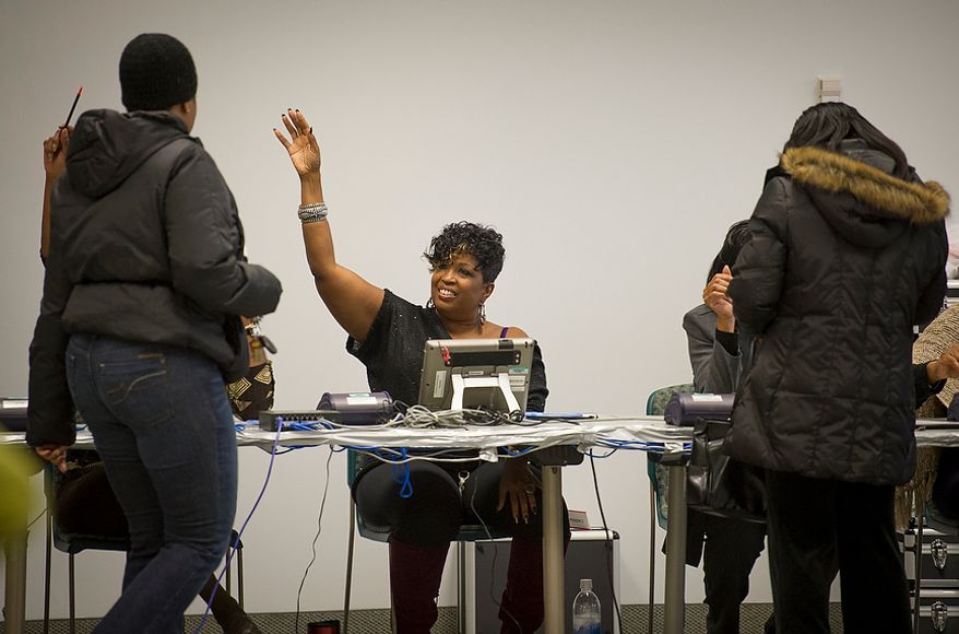 Election Judge Sharon Myles of Largo, Md., welcomes voters as hundreds of people turn out for early voting at the Prince George's Sports & Learning Complex in Landover, Md., on Wednesday, Oct. 31, 2012. (Rod Lamkey Jr./The Washington Times)