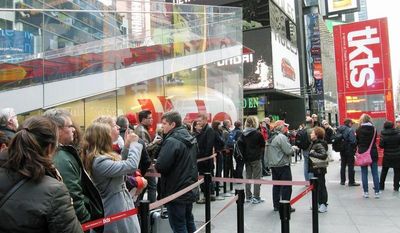 Purchasers wait patiently at the TKTS booth, which sells discount tickets to Broadway shows, in New York’s Times Square. Most Broadway theaters are reopening this week for regular performances in the aftermath of Superstorm Sandy. (Associated Press)