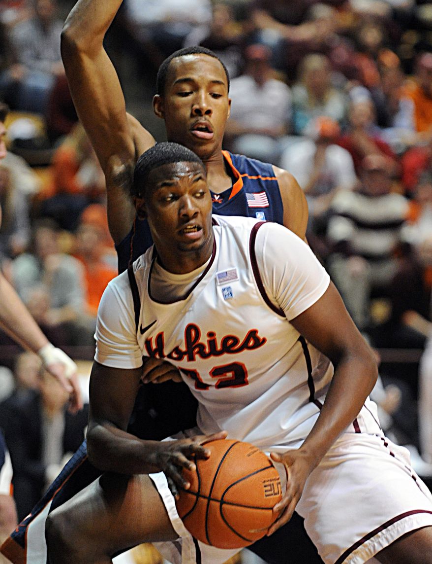 Virginia's Darion Atkins, rear, guards Virginia Tech's C.J. Barksdale during the second half of an NCAA college basketball game Tuesday, Feb. 21, 2012, at Cassell Coliseum in Blacksburg, Va. Virginia won 61-59. (AP Photo/Don Petersen)
