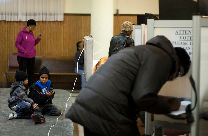 Children wait for their parents while they cast their ballots at St. Francis Church, precinct 111 polling site in Washington, D.C., to cast their vote, Tuesday, Nov. 6, 2012 (Craig Bisacre/The Washington Times)