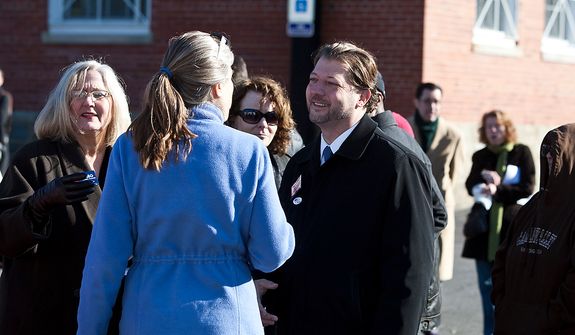 David Grosso, candidate running for at-Large City Council, shakes hands with voters outside of precinct 33 polling site in Washington, D.C., Tuesday, Nov. 6, 2012 (Craig Bisacre/The Washington Times) 