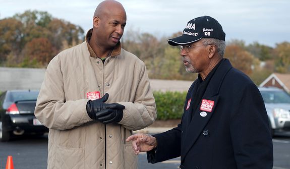 At large D.C. Council Member, Michael Brown, speaks with a volunteer outside of precinct 110 polling site in Washington, D.C., to cast their vote, Tuesday, Nov. 6, 2012 (Craig Bisacre/The Washington Times) 