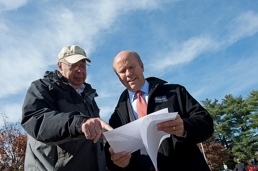 Jerry Garson (left) of the Ben Cardin campaign team, goes over data on Election Day with Maryland U.S. Congress hopeful John Delaney outside of Winston Churchill High School on Nov. 6, 2012. Delaney is hoping to oust Republican incumbent Roscoe Bartlett in the sixth district. (Barbara L. Salisbury/The Washington Times)