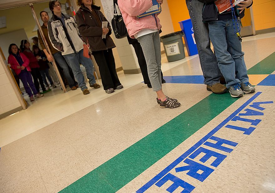 Voters wait in line on Election Day at Winston Churchill High School in Potomac, Md., on Nov. 6, 2012. (Barbara L. Salisbury/The Washington Times)
