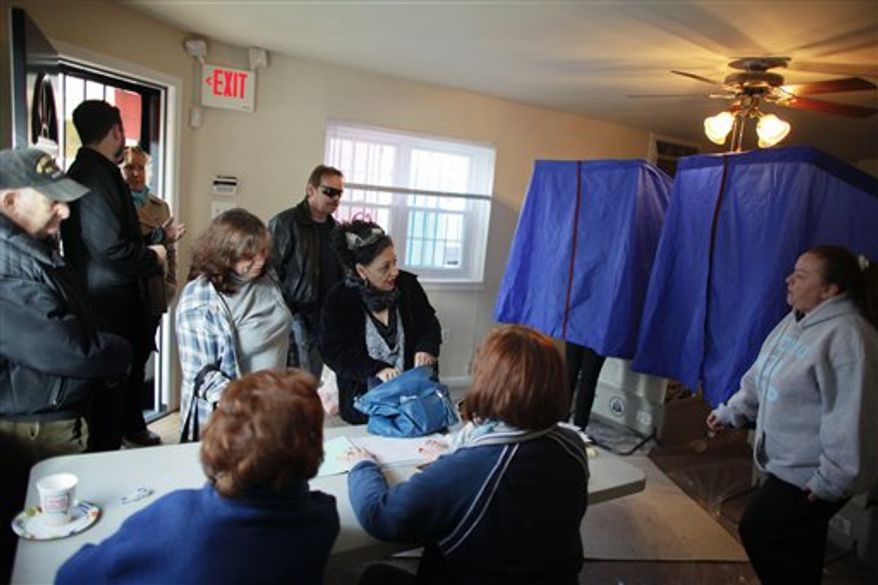 People cast their votes, Tuesday, Nov. 6, 2012, at a 1st Ward polling location in South Philadelphia. (AP Photo/ Joseph Kaczmarek)