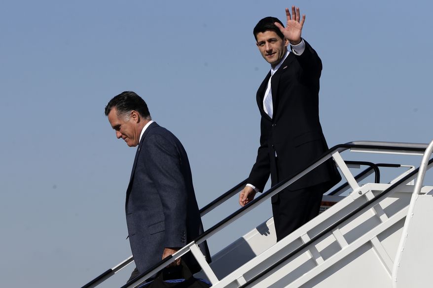 Republican presidential candidate Mitt Romney, followed by his vice presidential running mate, Rep. Paul Ryan, walks off Mr. Romney's plane in Cleveland on Tuesday, Nov. 6, 2012. Mr. Ryan arrived moments earlier on his own plane and met Mr. Romney on board. (AP Photo/Charles Dharapak)