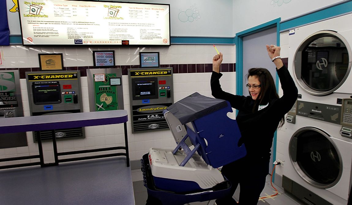 Leslie Fabian reacts after successfully voting electronically on Election Day at the 24-hour Su Nueva Laundromat in Chicago&#x27;s 13th Ward on Tuesday, Nov. 6, 2012. (AP Photo/Charles Rex Arbogast)