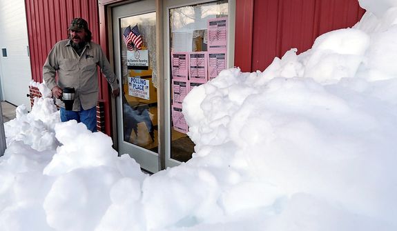 Snow surrounds the polling precinct in Terra Alta, W.Va., as Peter Hough heads to work after casting his ballot on Election Day, Tuesday, Nov. 6, 2012. (AP Photo/Dave Martin)