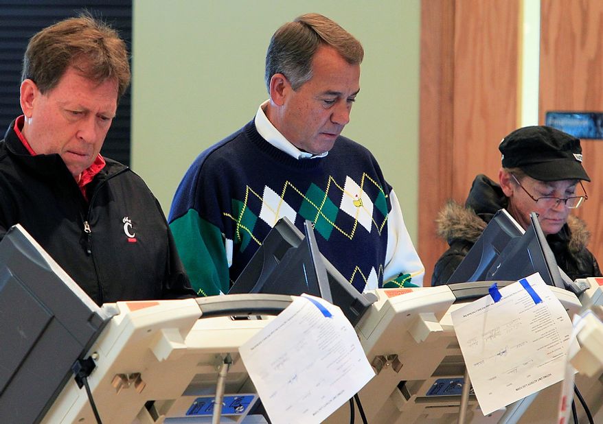 House Speaker John A. Boehner (center), Ohio Republican, votes at the Ronald Reagan Lodge on Tuesday, Nov. 6, 2012, in West Chester, Ohio. After a grinding presidential campaign, Americans are heading into polling places across the country. (AP Photo/Al Behrman)