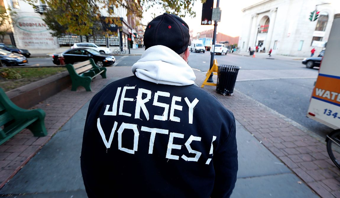 Ed Lippman, 58, wears a message on his jacket on Election Day while walking home, Tuesday, Nov. 6, 2012, in Hoboken, N.J. (AP Photo/Julio Cortez)