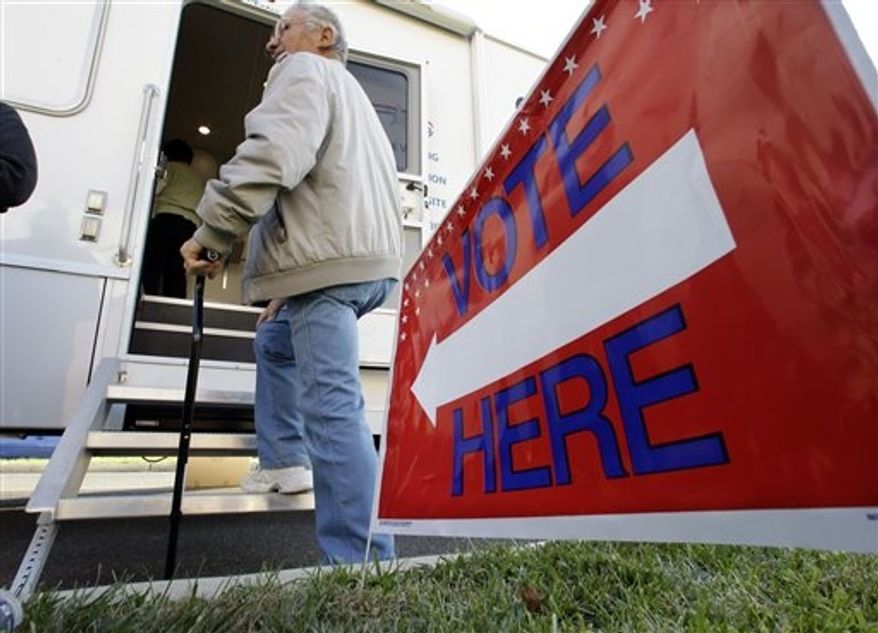 A man waits his turn to vote at a Mobile Voting Precinct van Monday, Nov. 5, 2012, in Burlington, N.J. Many victims displaced by Superstorm Sandy are taking advantage of offers to vote early. (AP Photo/Mel Evans)