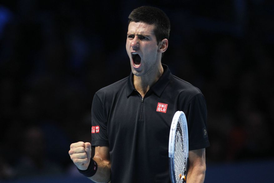 Novak Djokovic of Serbia reacts to a game win against Andy Murray of Britain during their ATP World Tour Finals singles tennis match at the O2 Arena in London, Wednesday, Nov. 7, 2012. (AP Photo/Sang Tan)