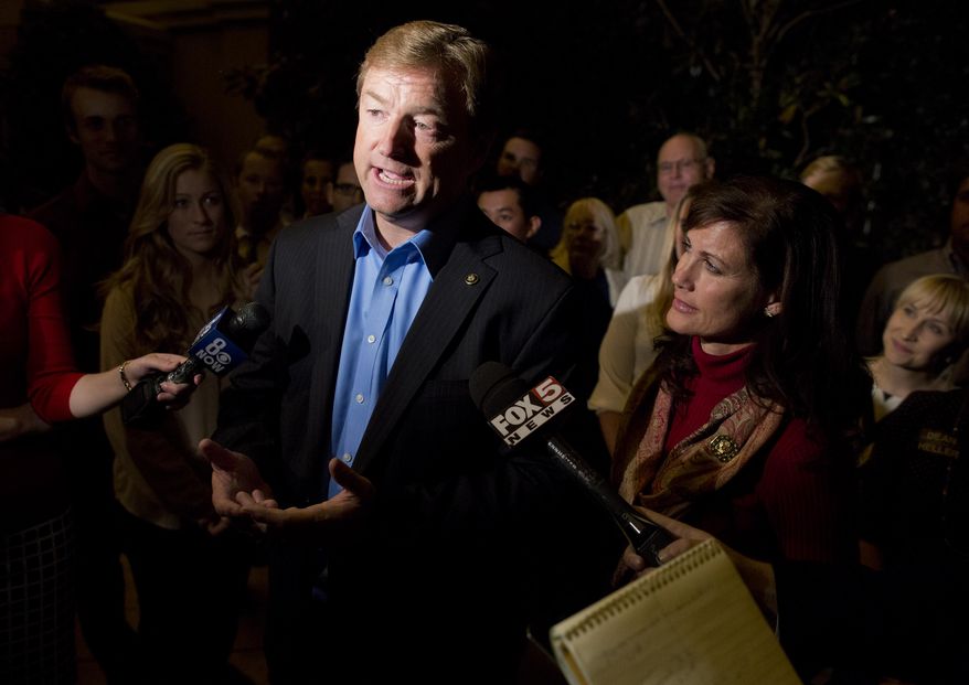 Sen. Dean Heller, Nevada Republican, talks to the media after winning re-election to the Senate over Rep. Shelley Berkley, his Democratic challenger, on Wednesday, Nov. 7, 2012, in Las Vegas. At right is his wife, Lynne. (AP Photo/Julie Jacobson)